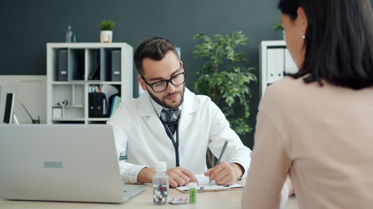 Clinician talking with a patient in the consultation room